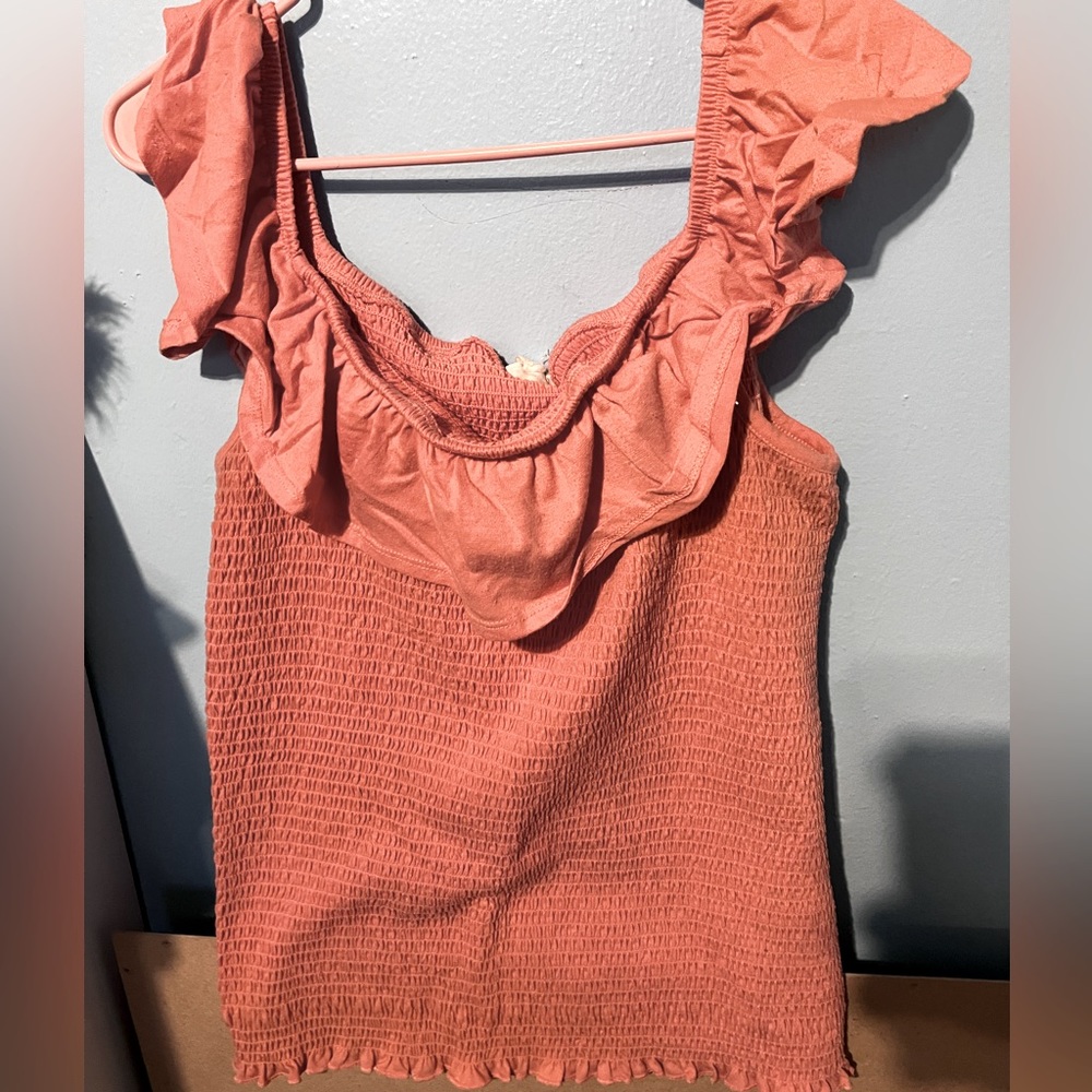 A pink ruffle shirt.